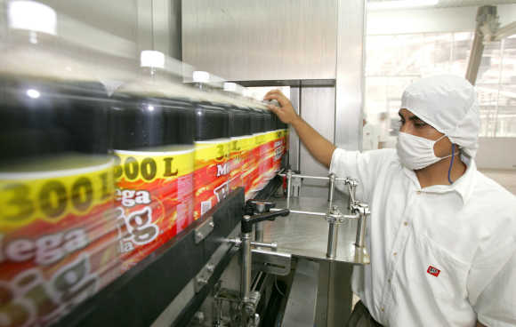 Mexican worker checks the quality of Big-Cola bottles at a plant in Huejotzingo, Mexico.