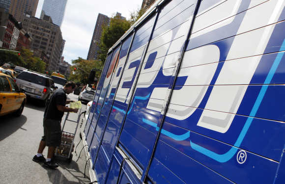 Workers unload a truck of Pepsi products in New York.