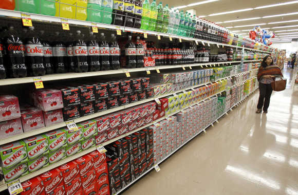 A shopper walks by the sodas aisle at a grocery store in Los Angeles.