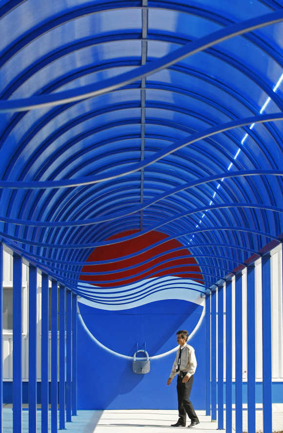 A security officer walks past the entrance of the second-largest European Pepsi plant near Bucharest.