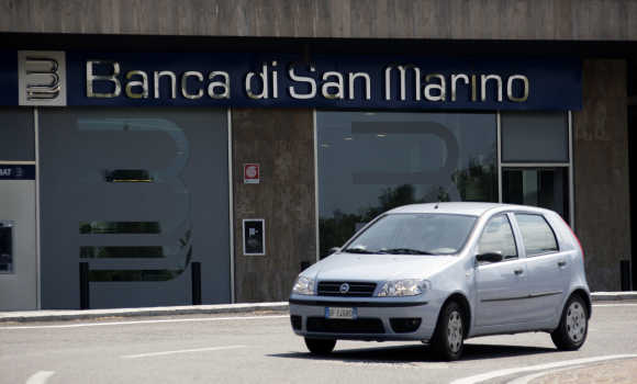 A car passes a branch of the Banca di San Marino in San Marino.