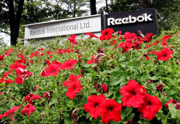 Flowers surround sign at entrance to world headquarters of Reebok in Canton, Massachusetts.