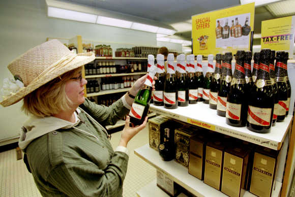 A customer purchases a bottle of champagne at one of the duty free shops at Schiphol airport in Amsterdam.