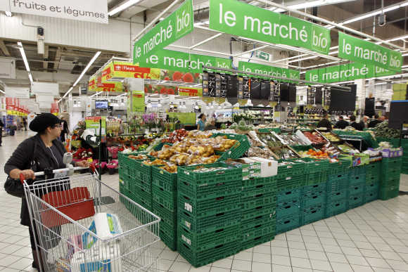 A shopper pushes a shopping trolley down an aisle at a supermarket in Charenton near Paris.
