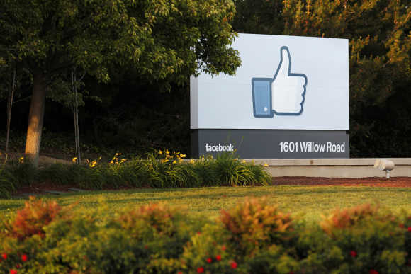 The sun sets on the entrance sign at Facebook's headquarters in Menlo Park, California, the night before its IPO launch.