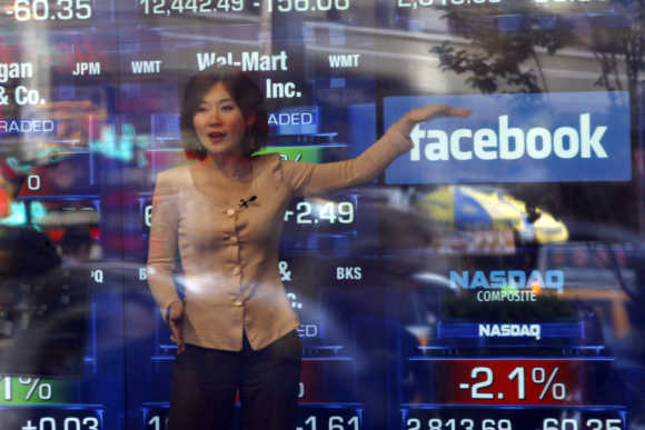 A television reporter talks about the Facebook IPO at the Nasdaq Marketsite in New York.