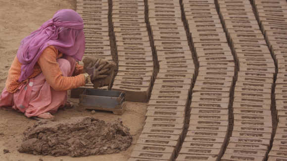 A labourer works in a brick factory at Togga village, in the outskirts of Chandigarh.