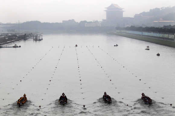 Participants compete in a dragon boat race to mark the upcoming Dragon Boat Festival in Keelung River in Taipei.