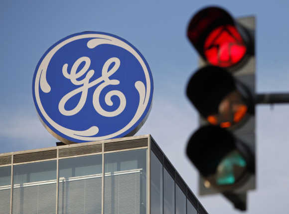 The logo of the GE is seen behind a traffic light in Prague.