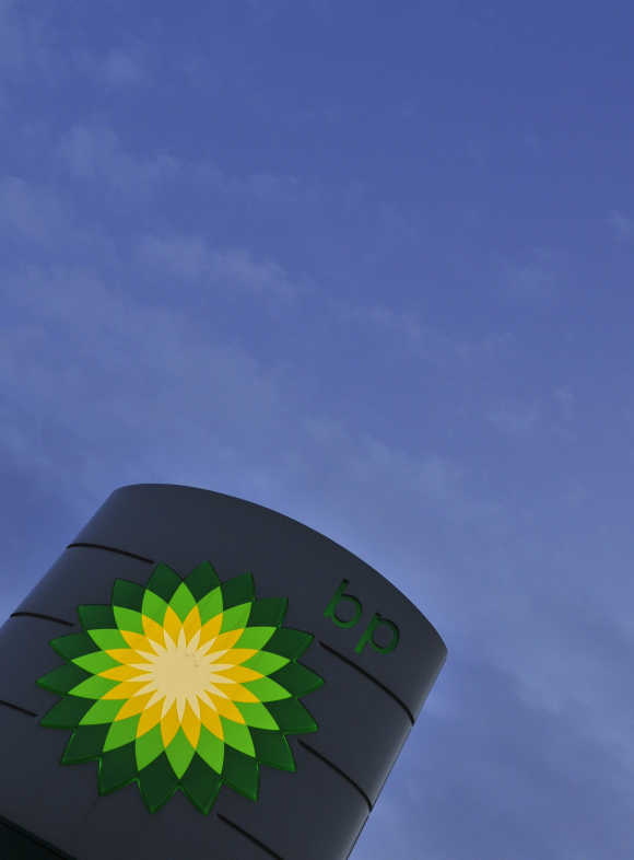 A BP petrol station sign is seen at dawn in west London.