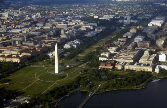 Downtown Washington is seen in an aerial view. At bottom left is the World War II memorial with the Washington Monument and National Mall at centre and the US Capitol building at upper right.