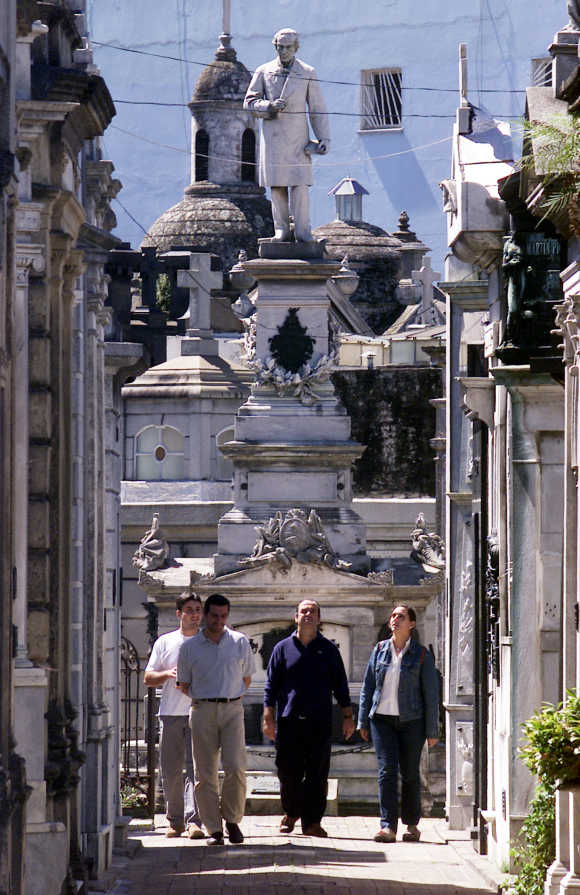 People walk past statues and mausoleums at Buenos Aires' Recoleta cemetery.