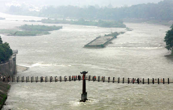 Visitors cross part of a 260-metre Anian cable bridge over Minjiang River at Dujiangyan, 50km north of Chengdu.