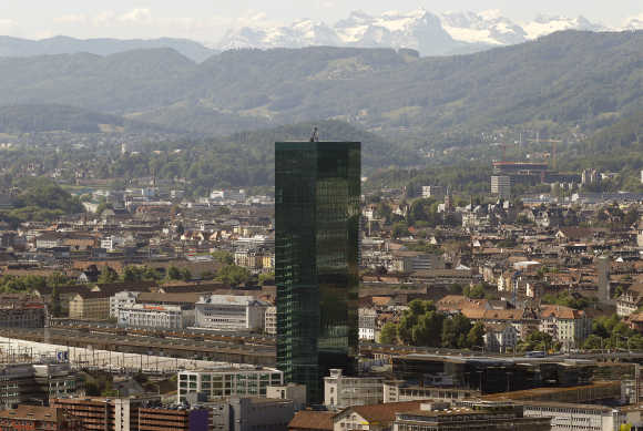 A view of the Prime Tower office building (126 metres) in Zurich in front of the eastern Swiss Alps.