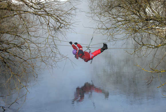 A tourist crosses a river in a suburb of the city of Gomel, some 320km southeast of Minsk.