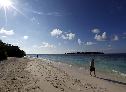 Tourists enjoy the beach at a resort island at the Male Atoll.