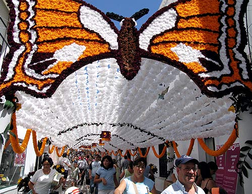 Tourists walk through the paper flower decorated streets of Campo Maior on the first day of the 'Flowers Festival' in central Portugal.