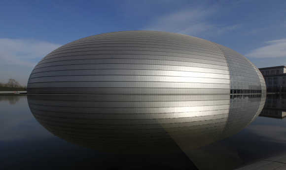 The National Grand Theatre, also known as the 'egg', is reflected in the water in central Beijing.
