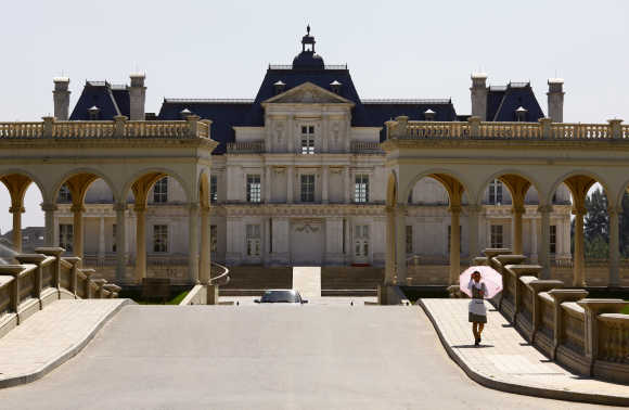 A waitress walks down the driveway to Chateau Laffitte Hotel located on the outskirts of Beijing.