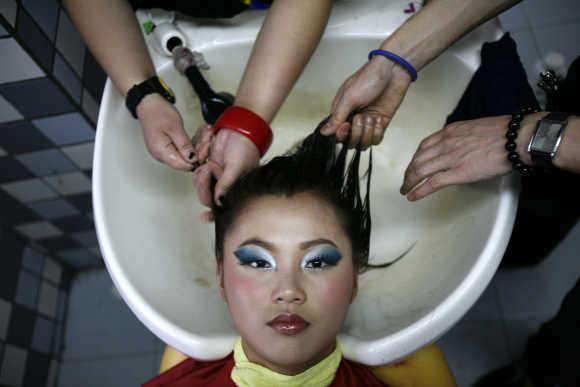 Students wash their classmate's hair as a part of a practice session in the China Fukang Beauty and Hair School in Shanghai.