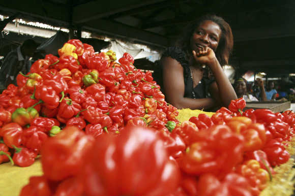 A vendor stands behind her vegetables on sale at the market in Calabar Delta region in Nigeria.
