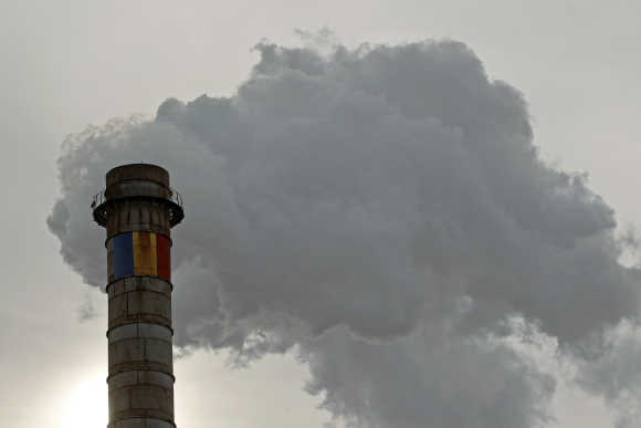 Romania's national flag is seen painted on a tower of a thermal energy production factory in Bucharest.