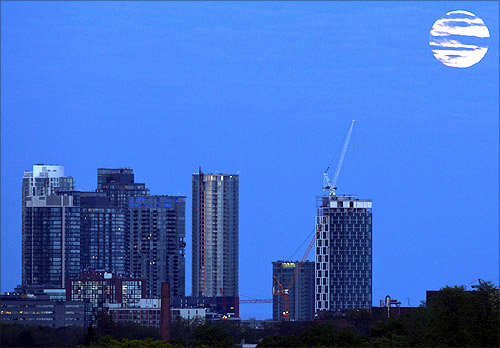 The super Moon rises over some apartment buildings in Toronto.
