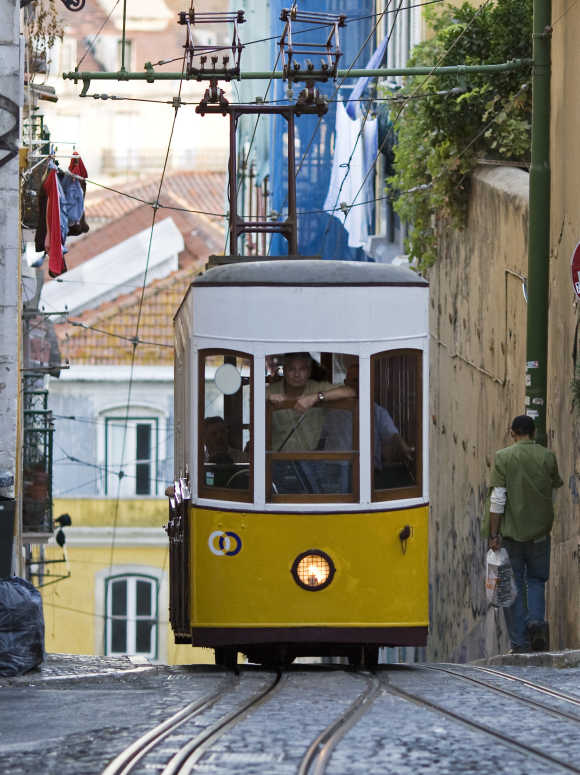 An employee looks through the open windscreen of Lisbon's Bica funicular. Different in shapes but serving one function - simplifying access to the upper town in the hilly Portuguese capital - Lisbon's street elevators are national monuments.