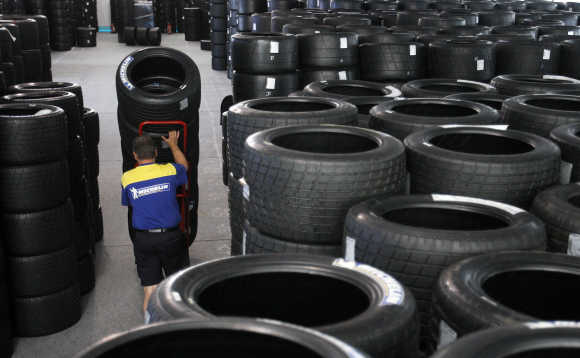 A member of French tyre manufacturer Michelin moves some of 8,000 tyres stocked on the racing circuit of Le Mans, France.