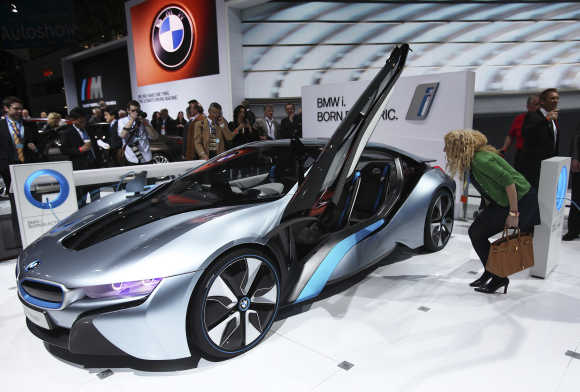 A visitor looks at the BMW i8 plug-in hybrid automobile in New York.