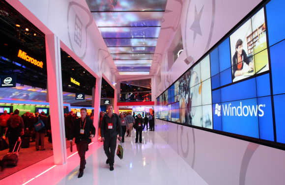 Showgoers walk through the Microsoft booth during the 2012 International Consumer Electronics Show in Las Vegas.