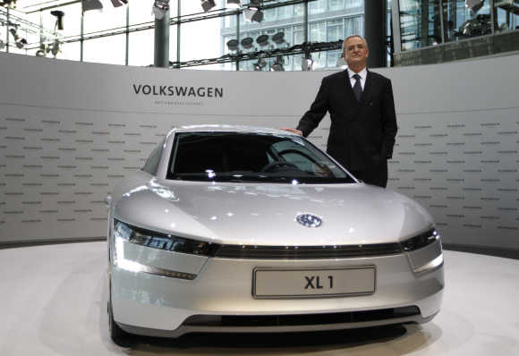 Volkswagen CEO Winterkorn poses beside a XL1 concept car before annual news conference in Wolfsburg, Germany.