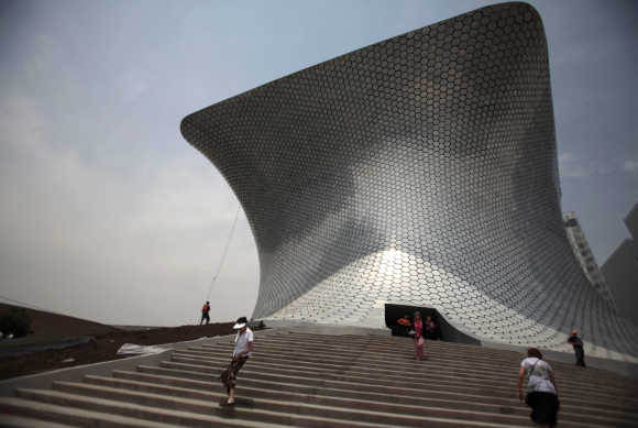 People walk outside the Soumaya Museum in Mexico City.