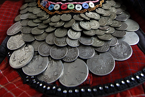 A detail of a decorative heirloom necklace made from coins worn by a member of the singing group Buranovskiye Babushki during a rehearsal in the village club in Buranovo in the central Russian region of Udmurtia.