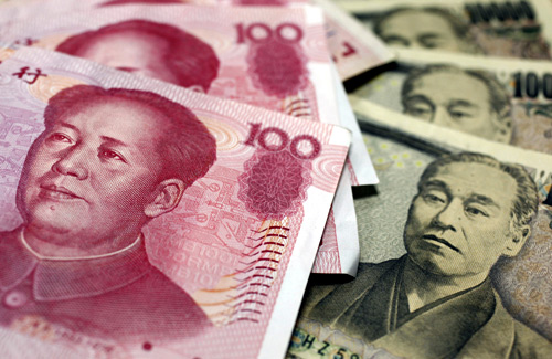 Yuan and Yen banknotes are seen in this picture illustration taken in Tokyo.