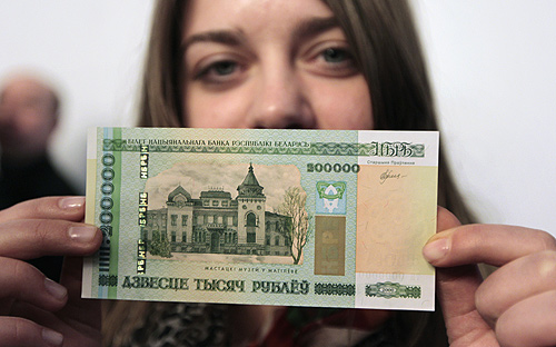 A woman holds a new 200,000 Belarusian ruble note ($24.48) during a presentation to the media in Minsk.