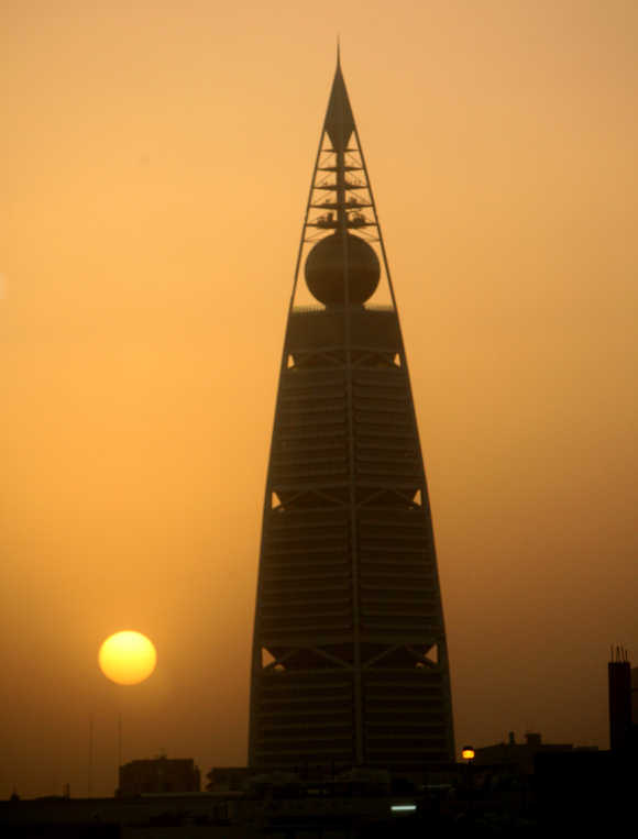 The sun sets behind Borg Al-Faisalya, one of the two main towers in Riyadh.