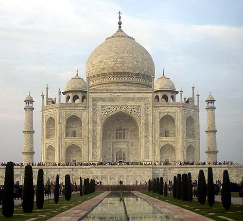 Tourists stand in front of the historic Taj Mahal in Agra.