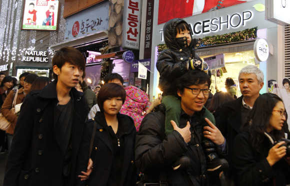 People walk on the street in central Seoul.