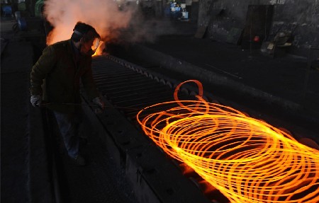 An employee works at a steel factory