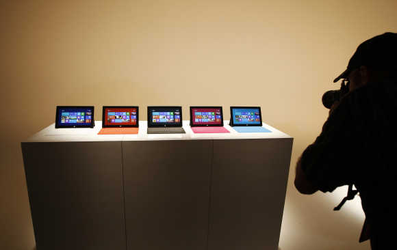 A photographer takes pictures of the Surface tablet computers on display in Los Angeles, California.