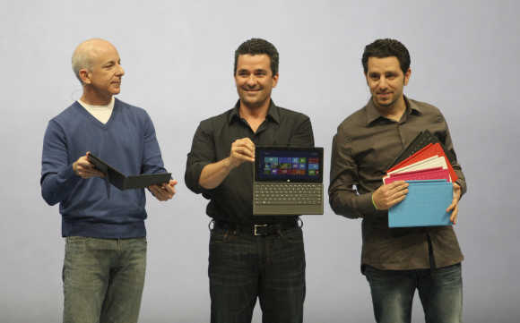 President of the Windows and Windows Live Division Steven Sinofsky, left; Corporate Vice-President of Windows Planning, Hardware and PC Ecosystem, Michael Angiulo; and GM of Microsoft Surface Panos Panay, right, hold the Surface tablet as it is unveiled in Los Angeles, California.