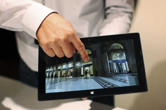A Microsoft representative scrolls the screen of the Surface tablet computer in Los Angeles, California.