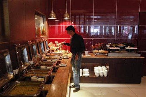 A guest looks at the buffet in a restaurant at the Keys Hotel Nestor in Mumbai.