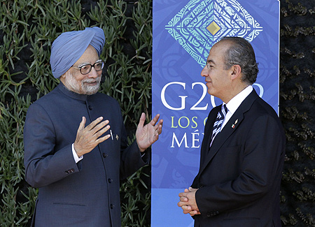 Prime Minister Manmohan Singh (L) is welcomed by Mexican President Felipe Calderon to the G20 Summit in Los Cabos.
