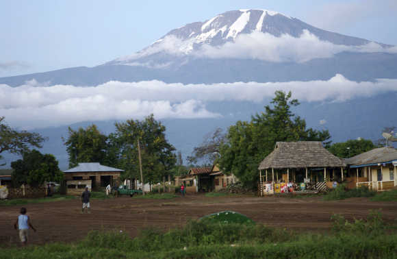 Houses are seen at the foot of Mount Kilimanjaro in Tanzania's Hie district.