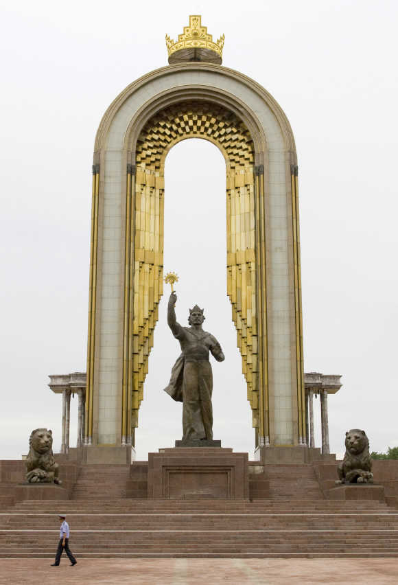 A policeman walks past the monument of Tajik state founder Ismoil Somoni in Dushanbe.