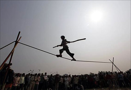 Eight-year-old Rupa performs on a tightrope at a roadside in Kolkata.