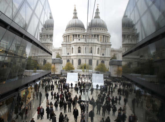 St Paul's Cathedral is reflected on the facade of the One New Change shopping centre in London.