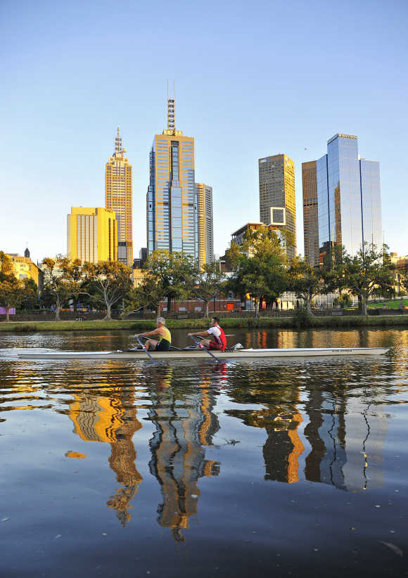 Rowers train at dawn on the Yarra River in Melbourne.